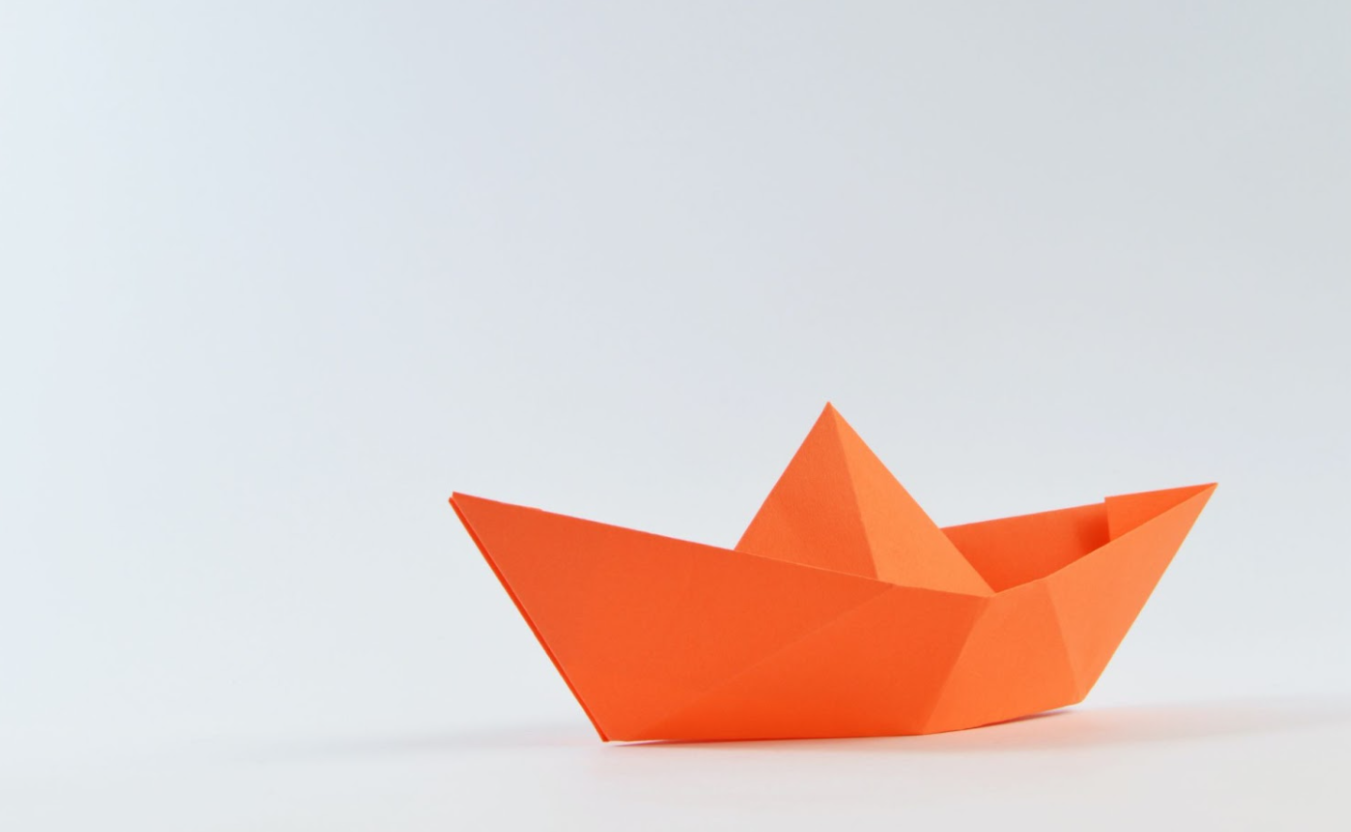 an orange paper boat