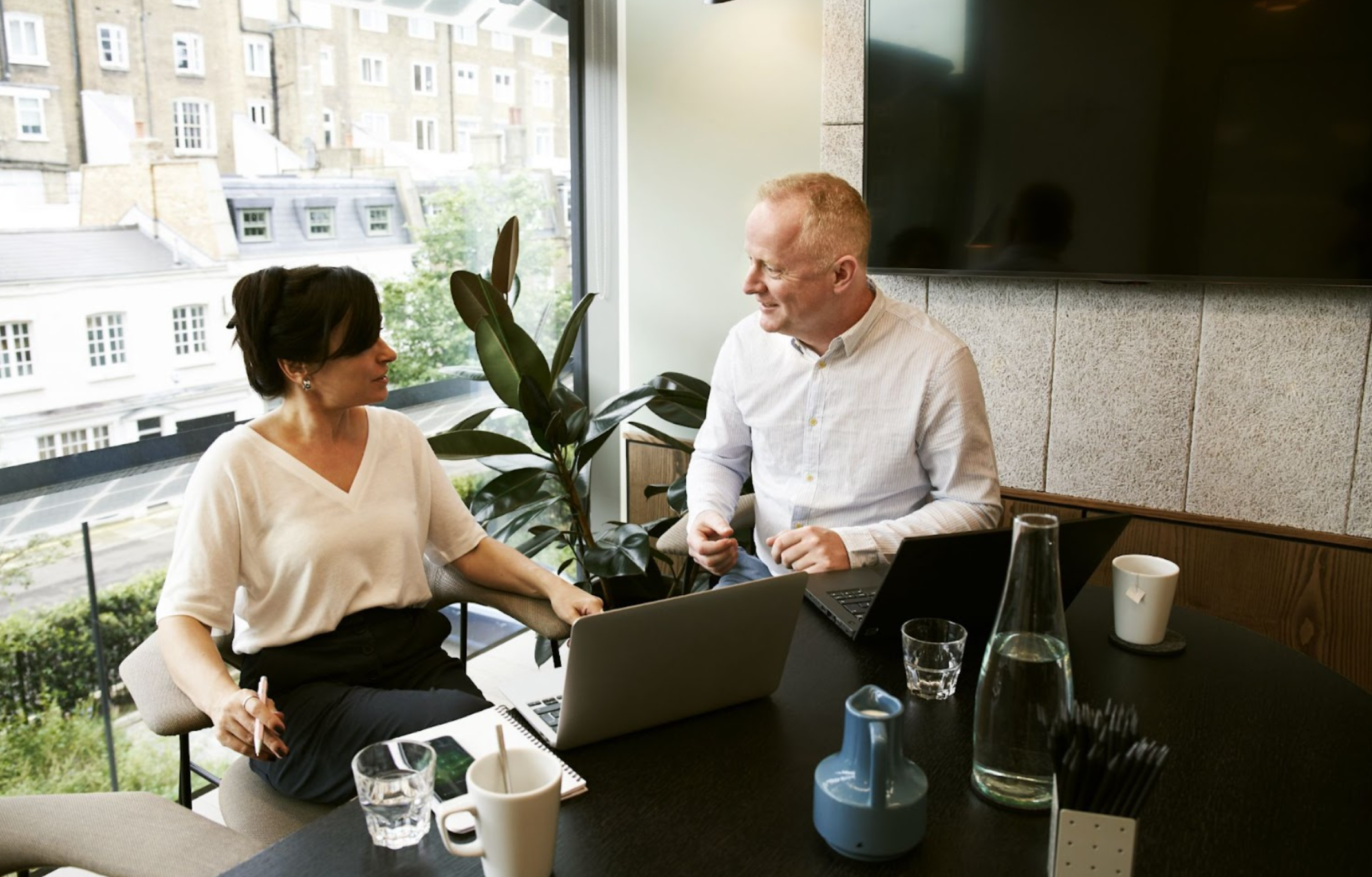 Two people talking to each other in an office