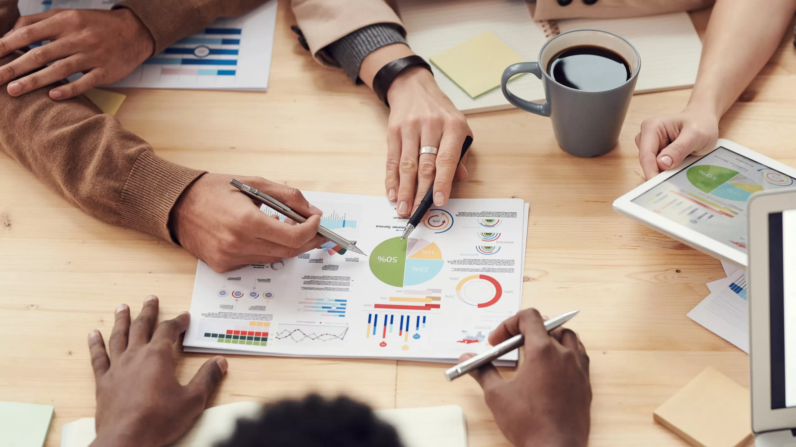 people working together to analyze a chart